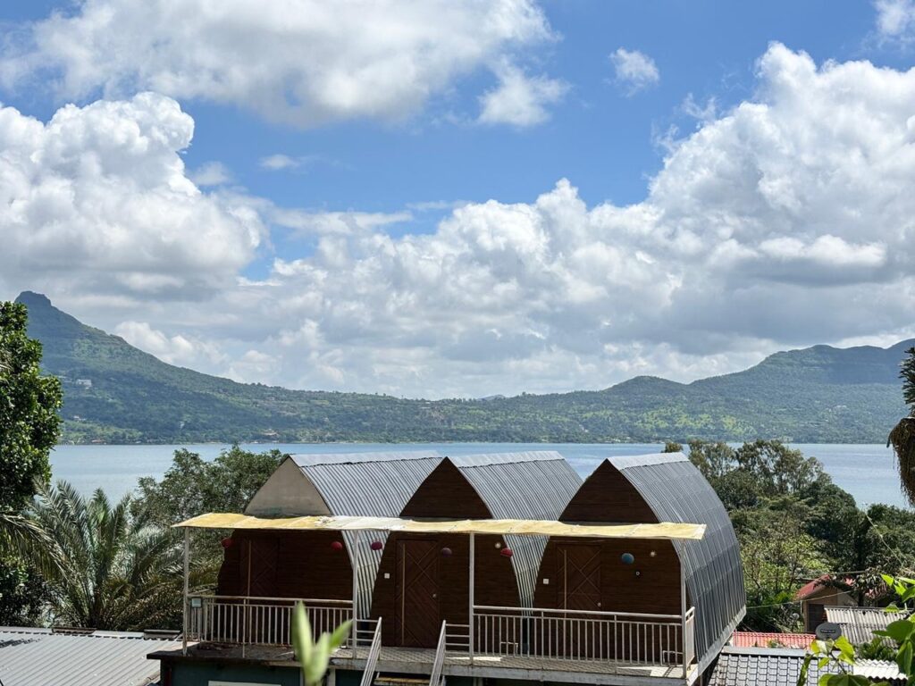 Pawna Lake camping for couples in winter – cozy lakeside cottage with balcony and sunset view